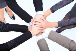 Closeup of successful business women with their hands together